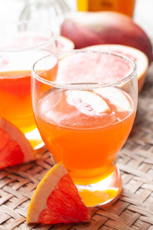 Grape fruit juice in glass on bamboo wooden backgroundの写真素材