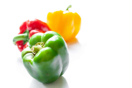 Green, yellow and red  sweet bell pepper or capsicum isolated on white backgroundの写真素材