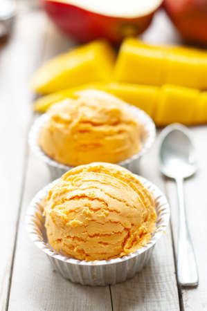Mango icecream on wooden boardの写真素材