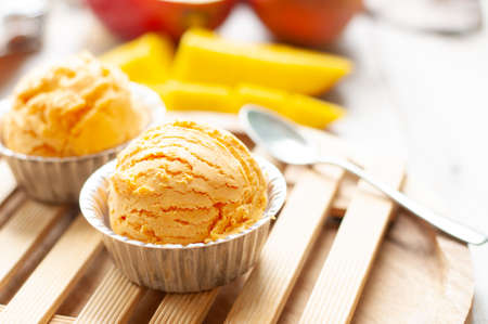 Mango icecream on wooden boardの写真素材