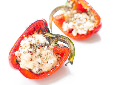Sweet pepper stuffed with chicken, cheese and quinoa isolated on white backgroundの写真素材