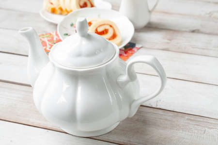 Teapot with Swiss Roll cake for teatimeの写真素材