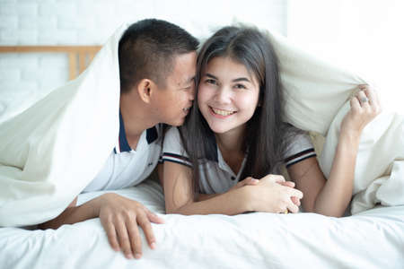 Portrait of couple on bedroomの写真素材