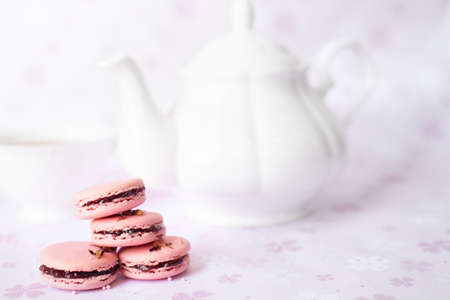 Pink macaroons on a pink background with afternoon tea ser, copy spaceの写真素材