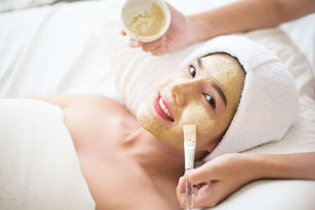 Spa beauty treatment, skincare. Woman getting facial care by beautician at spa salonの写真素材