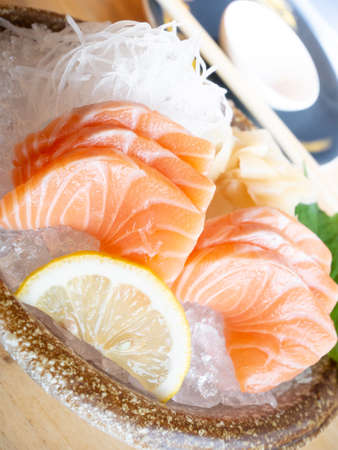 salmon sliced with lemon and iceの写真素材