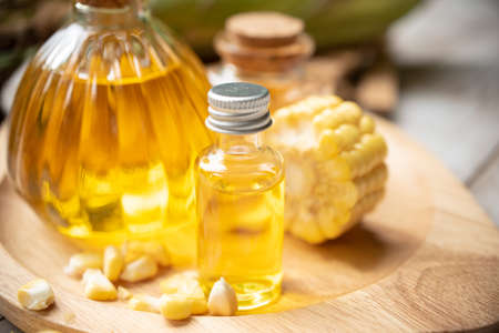 Corn oil in bottles with ears of cornの写真素材