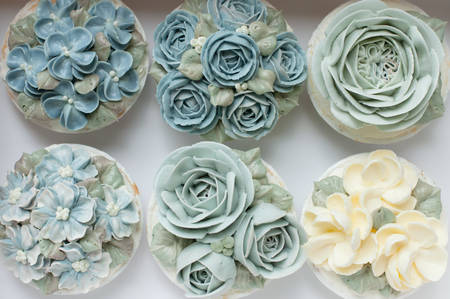 Blue flower buttercream cupcake on paper boxの写真素材