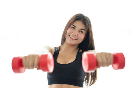 Woman in sportswear lifting dumbell isolated on white backgroundの写真素材
