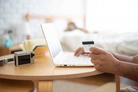 Man using laptop and credit card to shopping onlineの写真素材