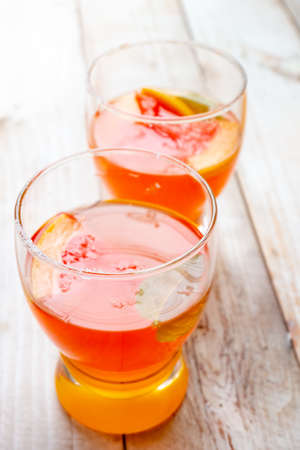 Grapefruit juice in glass on wooden backgroundの写真素材