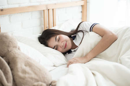 Woman sleeping in bedroom at the morningの写真素材