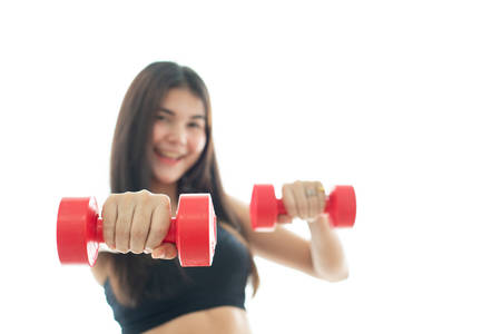 Woman in sportswear lifting dumbell isolated on white backgroundの写真素材