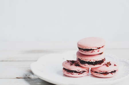 Rose flavor pink macaroons on grey wooden