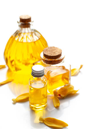 Ylang ylang perfume and  flower petals isolated on whiteの写真素材