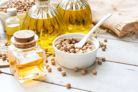 Soy bean oil in bottles on woodenの写真素材