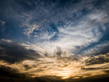 Dark orange and blue dramatic cloudy skyの写真素材