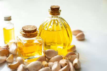 Olive oil with pepper, garlic, galangal and cinnamon isolated on whiteの写真素材