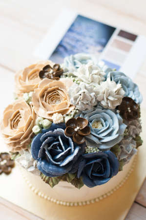 Orange and yellow butter cream flower cakeの写真素材