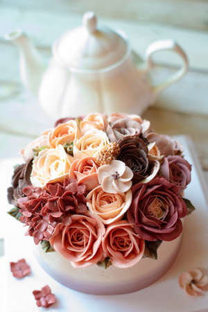 Buttercream flower cake with teapotの写真素材