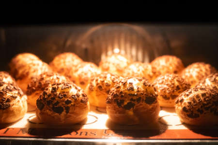 Close up, cream puff in oven. Selective focus. stock photo