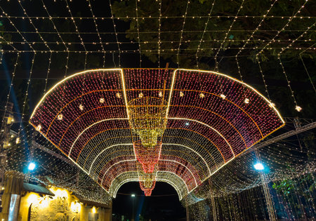 An Indian Festival of light, celebration of Diwali with a flashing light entrance with a glowing multi-colored arch. Beautiful wallpaper background at night.の写真素材