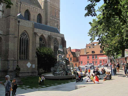 Bruges, Belgium - July 16, 2015: St. Salvator's Cathedral and modern sculpture with colorful windowsのeditorial素材