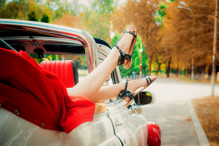 Summer road trip on a red and white retro cabriolet, outdoors photoの写真素材