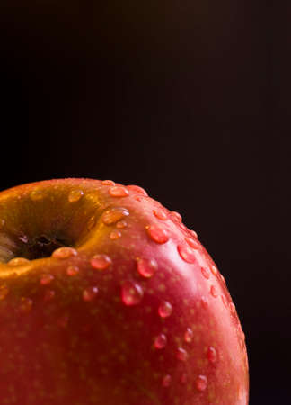 Wet red apple with drops close up, macroの写真素材
