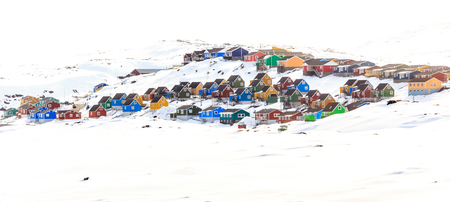Colorful cabins on the hill covered in snow, Aasiaat city, Greenlandの写真素材
