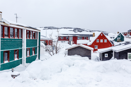Greenlandic Inuit houses among covered in snow  a suburb of arctic capital Nuuk, Greenlandの写真素材