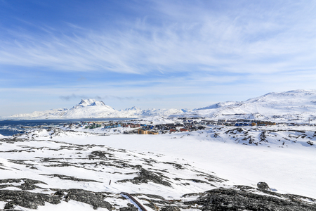 Nuuk city suburb at the fjord, snow landscape with blue sky and Sermitsiaq mountain in the background, Greenlandの写真素材