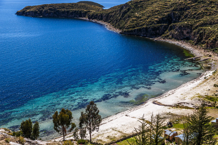 Blue water, coast of Titicaca lake and white sand beach at Incas Island of the Sun, Bolivia, south Americaの写真素材