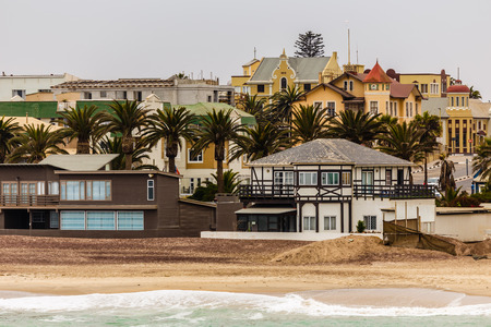 Coastline, palms and old blocks of Swakopmund German colonial town, Namibiaの写真素材