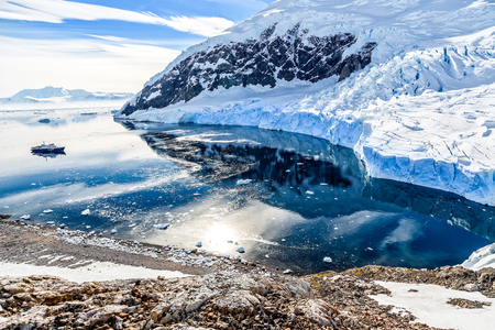 Antarctic mountain landscape with cruise ship standing still on the surface of Neco bay, Antarcticaのeditorial素材