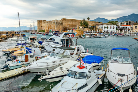 Kyrenia or Girne  historical city center, view to marina with many yachts and boats with Venetian castle and mountains in the background, North Cyprusのeditorial素材