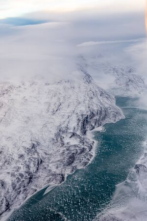 Greenlandic ice cap with frozen mountains and river aerial view, near Nuuk, Greenland