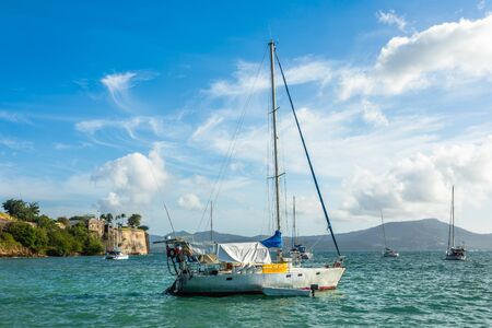 Yachts anchored in Fort De France harbor with fortress in the background, Fort-De-France,...