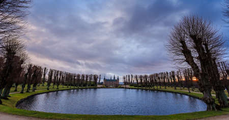 Frederiksborg castle on the sunset, with pond surrounded with trees in the foreground, Hillerod, Denmarkのeditorial素材