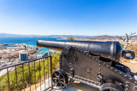 Old heavy cannon pointed towards Spain and the city downtown, Gibraltarの写真素材