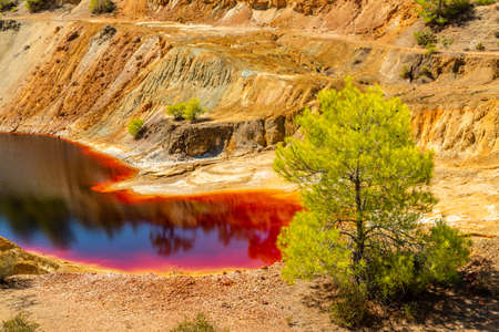 Dangerous bloody colored with copper pollution Sha mine lake, Nicosia, Cyprusの写真素材