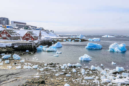 Nuuk old harbor panorama with blue icebergs drifting in the lagoon, Nuuk,, Greenland