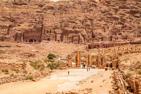 Petra main street with ancient Nabataean Royal tombs in the background and ruins of grand temple in the foreground, Petra, Jordanのeditorial素材