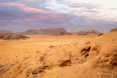Red sands, mountains, dramatic sky and marthian landscape panorama of Wadi Rum desert, Jordanの写真素材