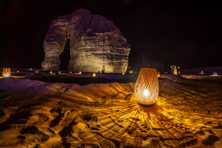 Illuminated sandstone elephant rock erosion monolith standing in the night desert, Al Ula, Saudi Arabiaの写真素材