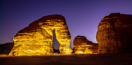 Illuminated sandstone elephant rock erosion monolith standing in the night desert, Al Ula, Saudi Arabiaの写真素材