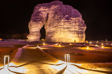 Illuminated sandstone elephant rock erosion monolith standing in the night desert, Al Ula, Saudi Arabiaの写真素材
