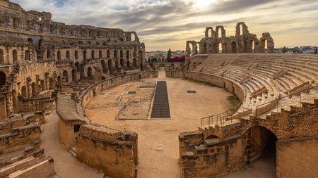 Entrance to ancient african Roman Colosseum amphitheatre arena panorama with ruins and columns, in...