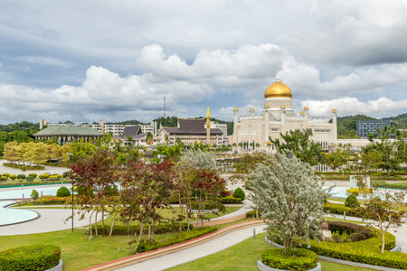 City central garden of Omar Ali Saifuddien Mosque golden domes and minarets with downtown in the background, Bandar Seri Begawan, Borneo, Sultanate Brunei Darussalamの写真素材