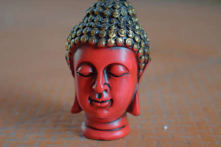 Peaceful red colored mural of buddhaの写真素材